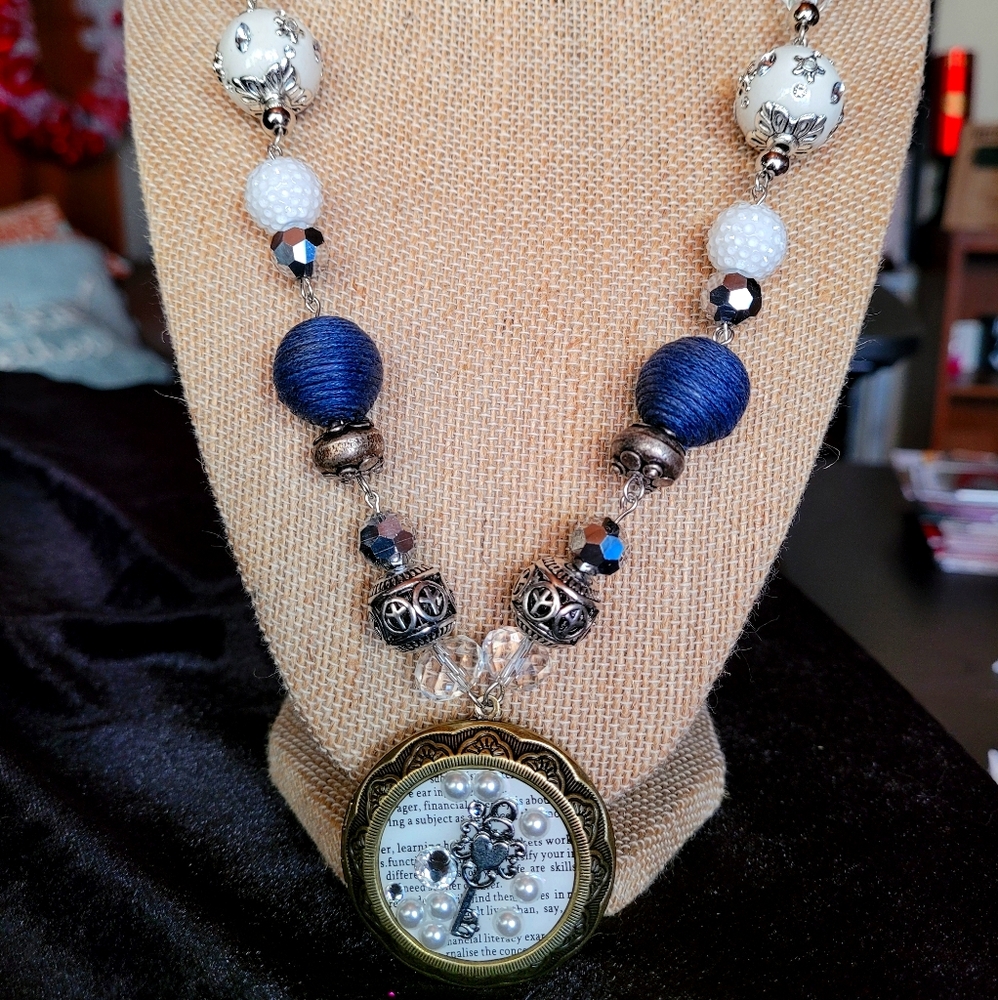 Women's Locket necklace with blues and whites.